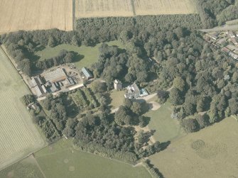 Oblique aerial view of the country house and farmsteading, taken from the SSW.