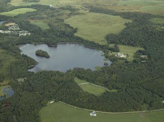 General oblique aerial view centred on Lochnaw Loch and towerhouse, with the towerhouse and country house adjacent, taken from the WNW.