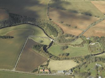 Oblique aerial view centred on the road bridge with the walled garden, bothy, church, burial-ground and churchyard adjacent, taken from the SE.