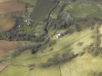 Oblique aerial view centred on the country house and stables with the gate-lodge, walled garden and the remains of the church adjacent, taken from the SE.