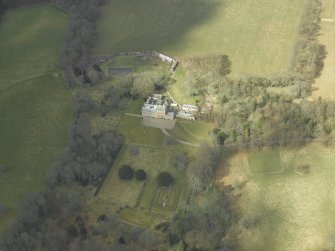 Oblique aerial view centred on the country house and gardens, taken from the SE.