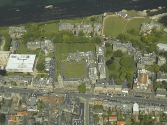 Oblique aerial view centred on the church, hall and colleges, taken from the S.