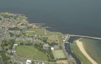 General oblique aerial view of the town centred on the remains of the cathedral and the harbour with the remains of the castle adjacent, taken from the S.