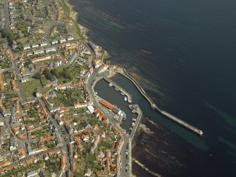 General oblique aerial view of the town centred on the harbour, taken from the W.