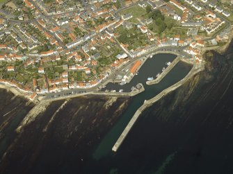 General oblique aerial view of the town centred on the harbour, taken from the S.