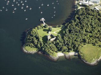 Oblique aerial view centred on the remains of the castle with the pier adjacent, taken from the N.