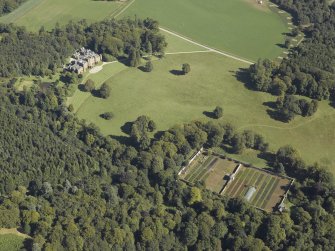 General oblique aerial view centred on the country house and walled garden, taken from the WSW.