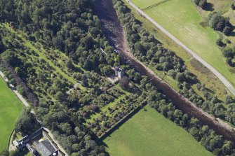 Oblique aerial view centred on the country house, walled garden and suspension bridge, taken from the ESE.