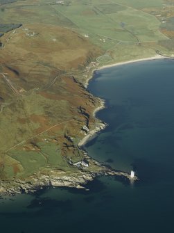 General oblique aerial view centred on Carraig Fhada lighthouse, Islay, houses and remains of the clearance cairns, taken from the SE.