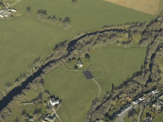 Oblique aerial view centred on the church, burial-ground, stables, farmsteading and manse, taken from the ESE.