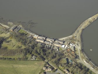 Oblique aerial view centred on the Port Edgar Royal Navy  barracks, officers' quarters, air raid shelter, stores, boiler house and gym, taken from the SSE.