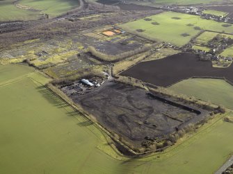 Oblique aerial view centred on former site of colliery, taken from the NW.