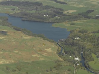 General oblique aerial view centred on the reservoir with the dam and the power station in the foreground, taken from the SSW.