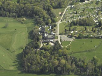 Oblique aerial view centred on the country house with the caravan park adjacent, taken from the NNW.