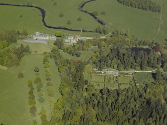 Oblique aerial view centred on the walled garden with Blairquhan House and stable block adjacent, taken from the S.