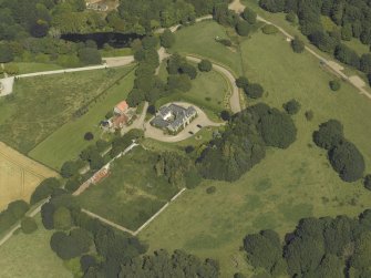 Oblique aerial view centred on the coach house and walled garden, taken from the SSW.
