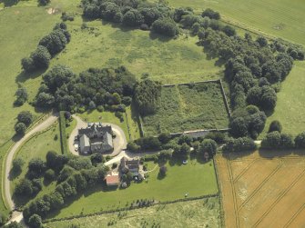 Oblique aerial view centred on the coach house and walled garden, taken from the NNW.