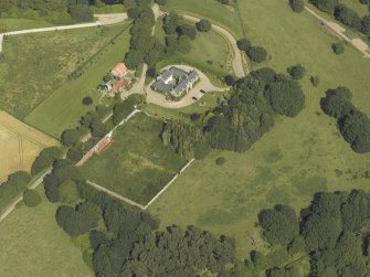 Oblique aerial view centred on the coach house and walled garden, taken from the SW.