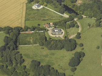 Oblique aerial view centred on the coach house and walled garden, taken from the S.