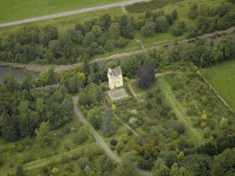 Oblique aerial view centred on the castle and garden with the suspension bridge adjacent, taken from the S.