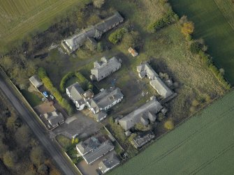 Oblique aerial view centred on the house and hospital buildings, taken from the SE.