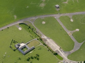 Oblique aerial view centred on Muirhouses farmsteading with the control tower and part of the dispersal area adjacent, taken from the E.