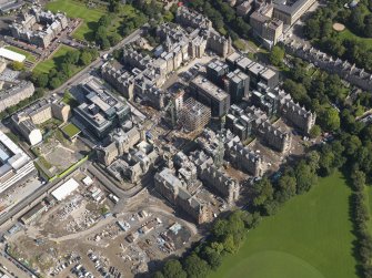 Oblique aerial view centred on the Quartermile development and the former Edinburgh Royal Infirmary, taken from the SW.