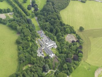 General oblique aerial view centred on the hotel with the stables adjacent, taken from the NW.