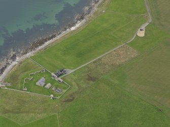 Oblique aerial view centred on the early 19th century gun battery with the Martello Tower adjacent, talen from the NW.