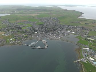 General oblique aerial view centred on the harbour with the town adjacent, taken from the NNW.