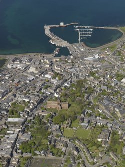 General oblique aerial view of Kirkwall centred on St Magnus' Cathedral with the harbour beyond, taken from the S.
