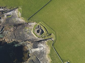 Oblique aerial view centred on Midhowe broch, Rousay, taken from the SSW.