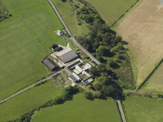 Oblique aerial view centred on the farmsteading, taken from the NNE.