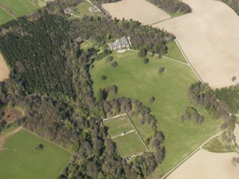 Oblique aerial view of the country house with the walled garden adjacent, taken from the S.