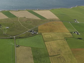 General oblique aerial view centred on the cropmark of the possible cairn at Buckan with the Ring of Bookan adjacent, taken from the S.