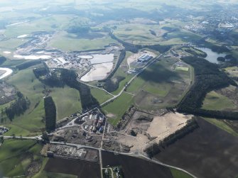 General oblique aerial view looking along Hyndford Road of the redevelopment of Winston Barracks with Lanark racecourse and the Hyndford sand and gravel workings beyond, taken from the E.