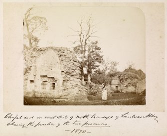 View of abbey with two people.
Titled: 'Chapel end on east side of north transept, Lindores Abbey showing the portion of the two piscurns. 1870'.