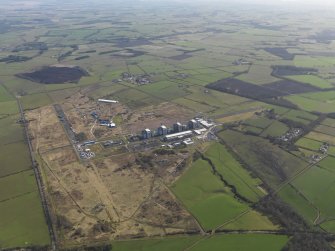 General oblique aerial view centred on the Nuclear power station with the airfield adjacent, taken from the SW.