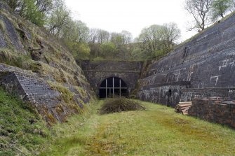 View from SSE showing tunnel mouth and retaining walls at entrance.