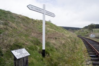 Detail S of Whitrope tunnel S entrance showing modern signpost/milepost connected to the Heritage Centre.