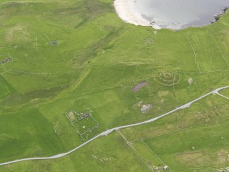 Oblique aerial view of the Broch of Underhoull and the field systems, looking WSW.
