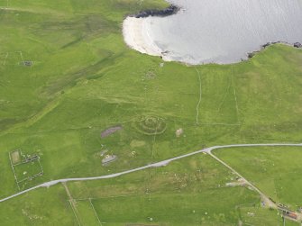 Oblique aerial view of the Broch of Underhoull and the field systems, looking WSW.