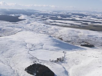 General  view of Woden Law fort and linear earthworks, and the Roman road in snow, looking WSW.