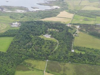 General oblique aerial view of Gigha centred on Achamore House and its policies, taken from the ESE.