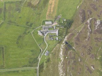 Oblique aerial view of Oronsay Farm and Priory, taken from the SE.