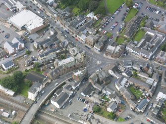 Oblique aerial view of Lockerbie centred on the Town Hall, taken from the NE.