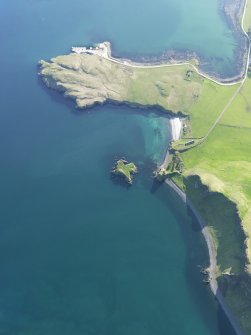 Oblique aerial view of Coroghan Castle and the pier on Canna, taken from the ENE.