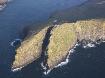 Oblique aerial view of  the remains of  Dun Briste and Sron an Duin, near Barra Head lighthouse overlooking the sea cliffs of Berneray, taken from the SW.