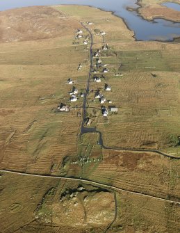 General oblique aerial view centred on the stone circle and stone row, the remains of the buildings and lazy beds at Calanais on the Isle of Lewis, taken from the SSW.