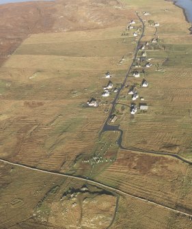 General oblique aerial view centred on the stone circle and stone row, the remains of the buildings and lazy beds at Calanais, taken from the S.